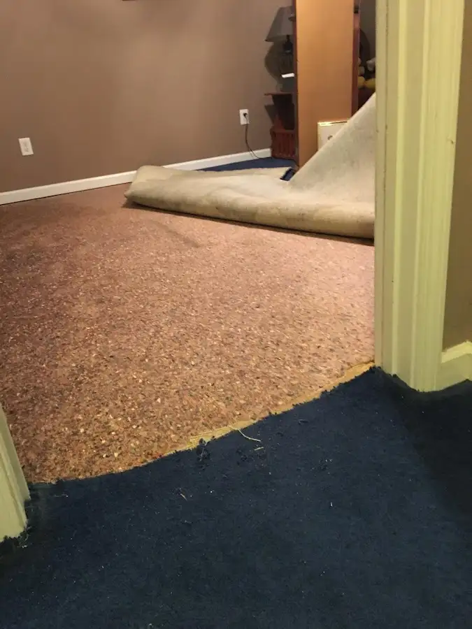 Carpet pad removal revealing water damage during Drying & Dehumidification in Grand Blanc